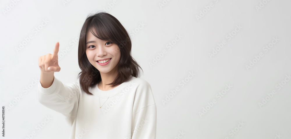 Pointing finger of an Asian girl highlights vacant space on a white background, making it a prime choice for a promotional advertising banner. Generative AI. Pointing finger of an Asian girl highlights vacant space on a white background, making it a prime choice for a promotional advertising banner. Generative AI.