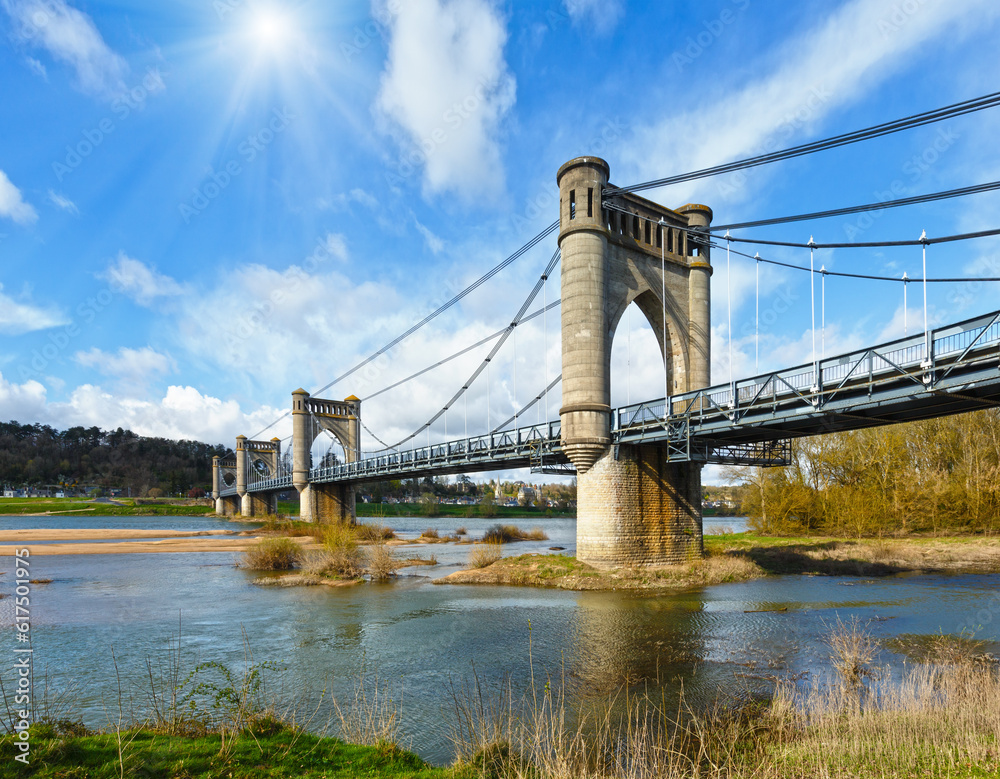 Obraz premium Sunshine above spension Bridge spanning the Loire in Langeais, France. Built between 1846 and 1849. Architect Phidias Vestier.