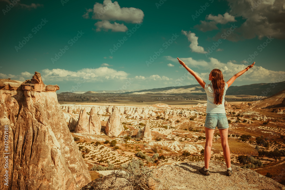 Girl standing on background of rocks formations of Cappadocia in Central Anatolia, Turkey Girl standing on background of rocks formations of Cappadocia in Central Anatolia, Turkey