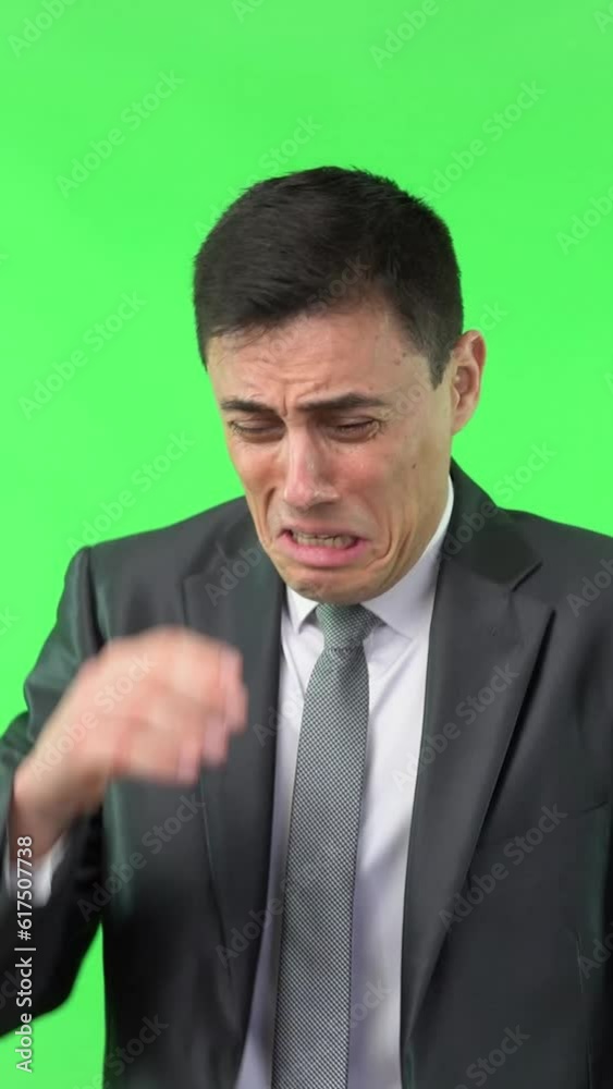 Crying man in formal suit against chroma key Crying man in formal suit against chroma key