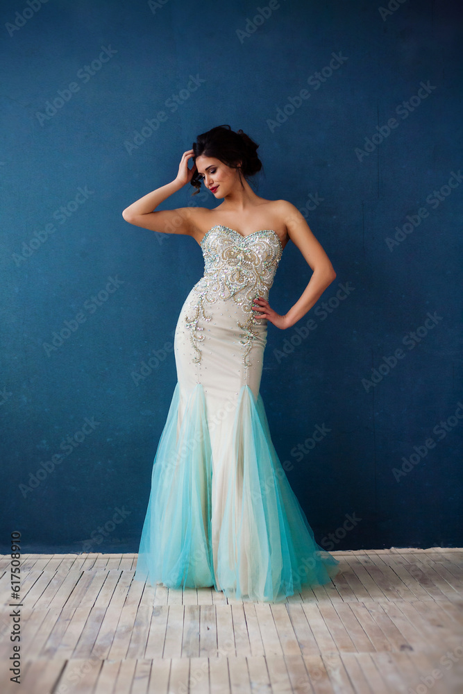 Beautiful woman in elegant evening dress. Professional make-up and hairstyle. Perfect skin. Fashion photo.