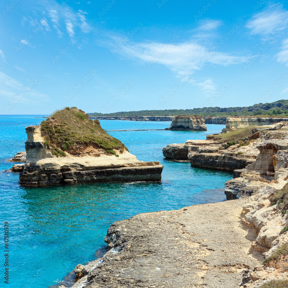 Obraz premium Picturesque seascape with white rocky cliffs, sea bay and islets at Grotta dello Mbruficu, Salento Adriatic sea coast, Puglia, Italy