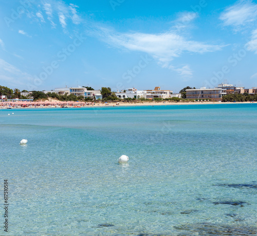 Picturesque Torre Chianca beach white sandy on Salento Ionian sea coast, Porto Cesareo, Puglia, Italy. People unrecognizable.