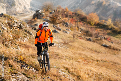 Mountain Bike traveler riding single track at foggy morning on hills. healthy lifestyle active athlete riding wild countryside. Cycle traveling concept.