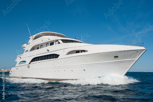 A large private motor yacht under way sailing out on tropical sea