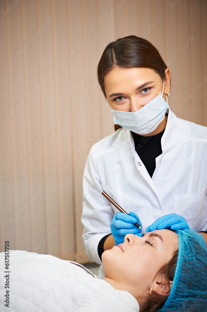 Permanent make-up master makes eyebrow correction procedure. Permanent makeup. Permanent make-up master makes eyebrow correction procedure. Permanent makeup.