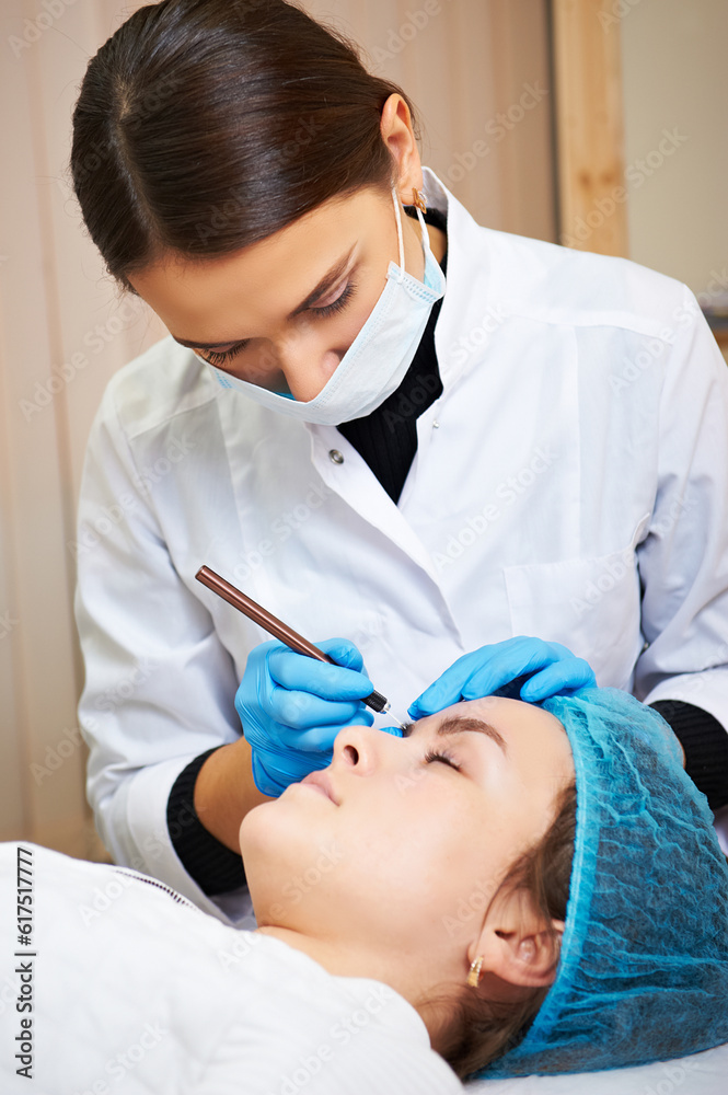 Permanent make-up master makes eyebrow correction procedure. Permanent makeup. Permanent make-up master makes eyebrow correction procedure. Permanent makeup.