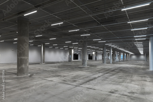 Abstract empty parking interior with concrete pillars and neon lights
