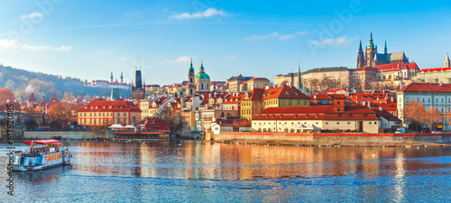 Old town of Prague, Czech Republic over river Vltava with Saint Vitus cathedral on skyline. Bright sunny day with blue sky. Praha panorama landscape view.