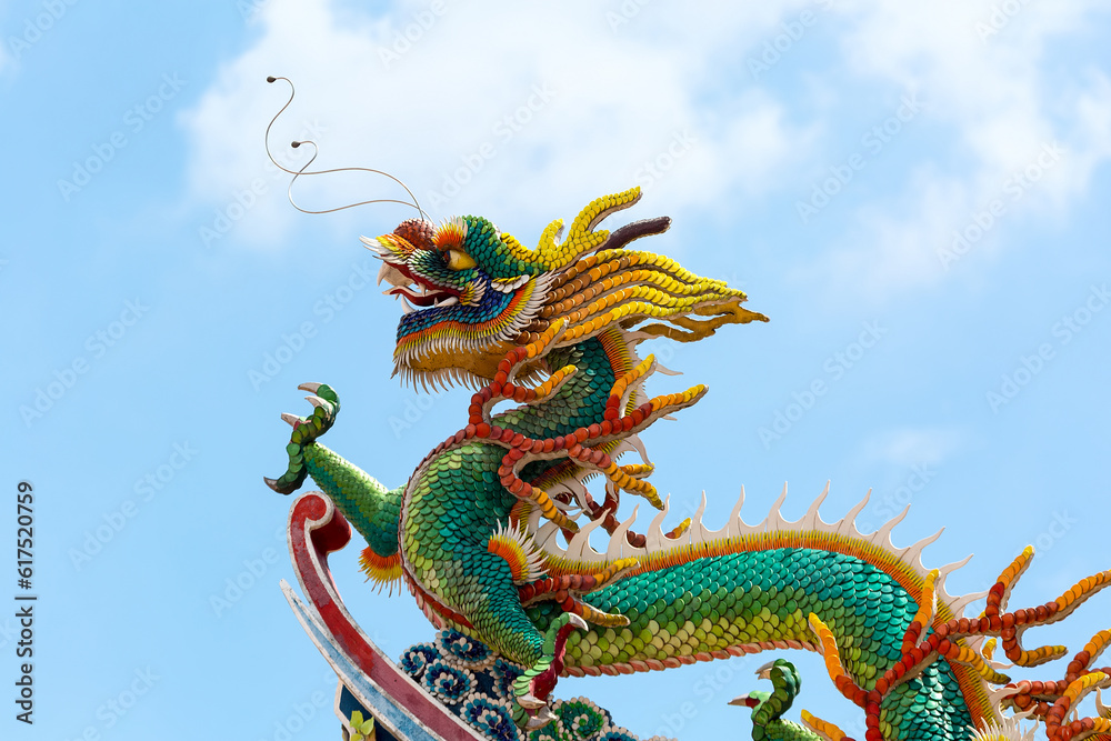 Fototapeta premium Ornate Colorful Chinese Dragon on rooftop of Chinese temple