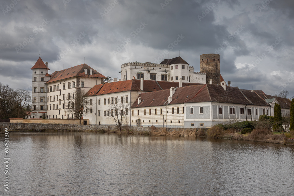 View of the castle by the pond in the center of Jindřichův Hradec on a cloudy spring day