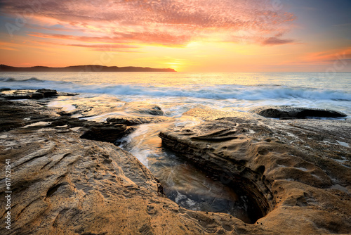 Spectacular sunrise beautiful skies and light from the rocky coastline near Pearl Beach, Australia