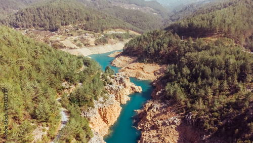 Aerial view of a beautiful canyon and a river with turquoise fresh water. Nature travel background. Reservoir on the Dimchay River from a bird's eye view.