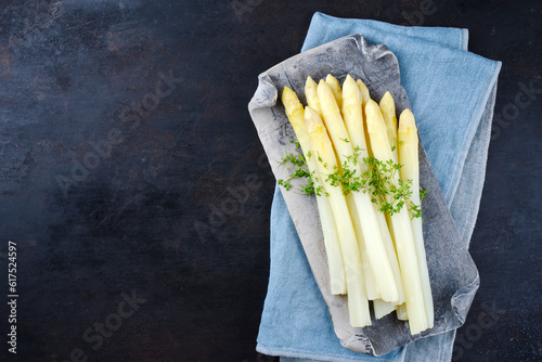White asparagus glazed with cress served as top view on a design tray with text space left