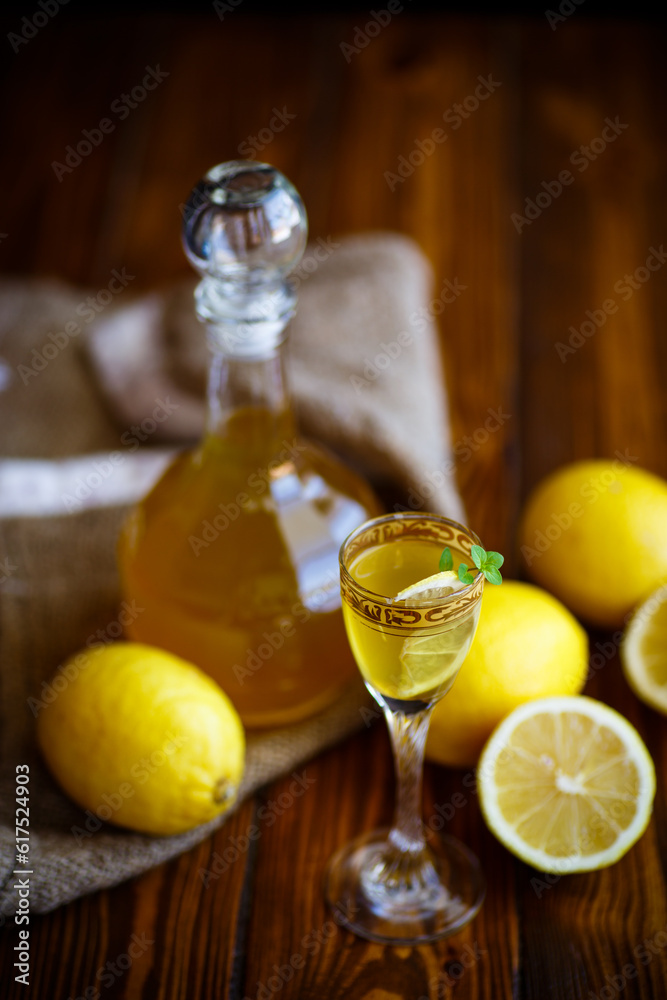 sweet lemon alcoholic brandy in the decanter on a dark table sweet lemon alcoholic brandy in the decanter on a dark table