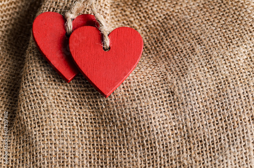 Couple of decorative wooden red hearts for Valentine's day on canvas background