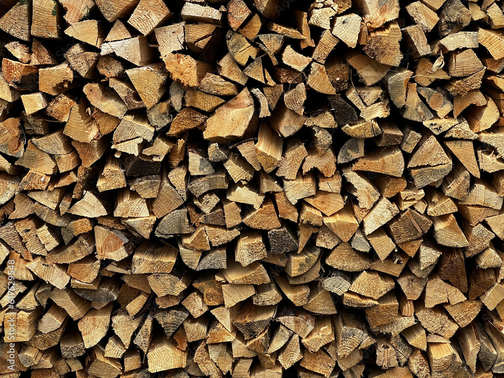 An ax on a stump against the background of stacked firewood An ax on a stump against the background of stacked firewood