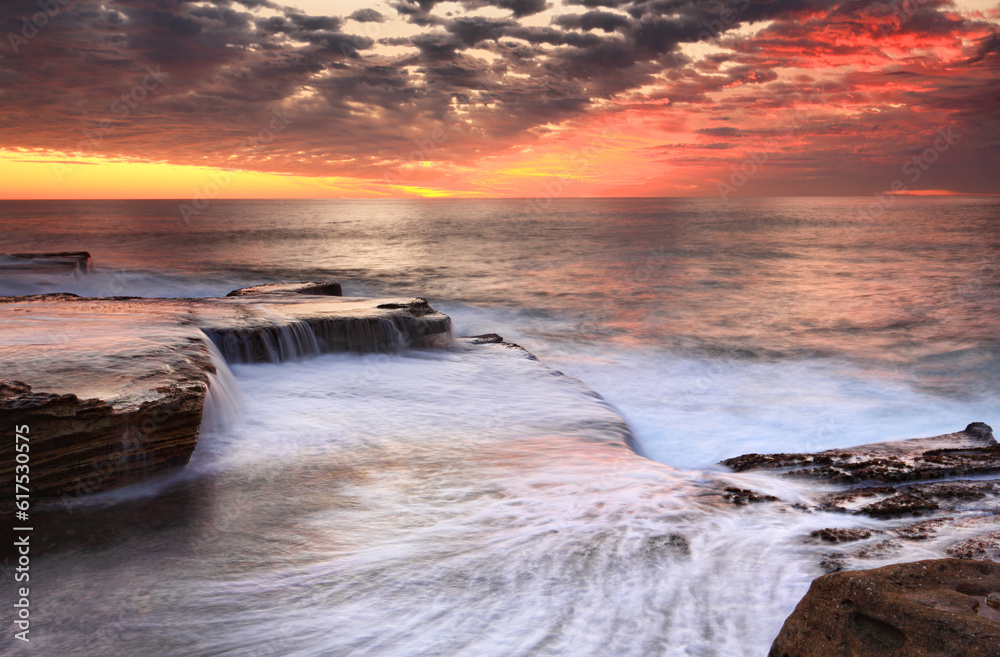 Ocean waves smash onto the rocks and then retreat in a marvelous dispolay or waterfall cascades at Maroubra, near Sydney Australia. Ocean waves smash onto the rocks and then retreat in a marvelous dispolay or waterfall cascades at Maroubra, near Sydney Australia.
