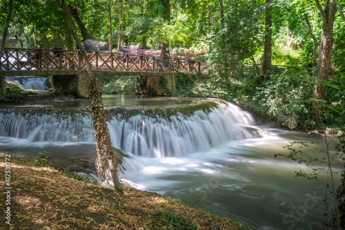 Stone monastery garden park with lush waterfalls