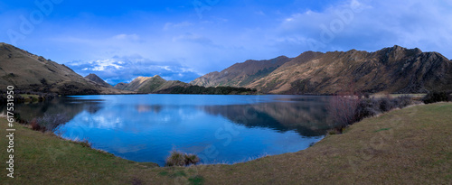 Photograph of Lake Moke with mountains reflecting in the water on a cloudy day outside Queenstown on the South Island of New Zealand