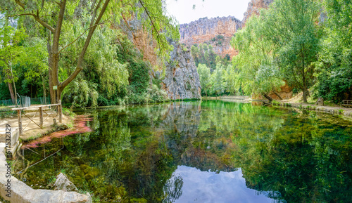 Stone monastery garden park with lush waterfalls