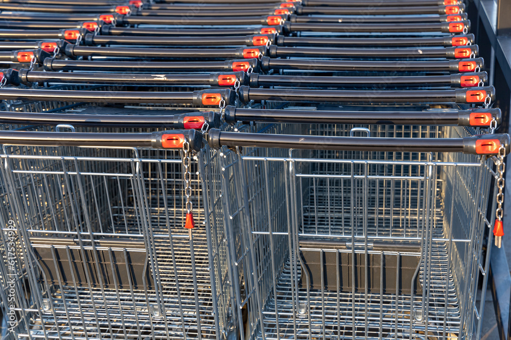 Lots of empty shopping carts. Rows of shopping carts next to a supermarket. Close-up