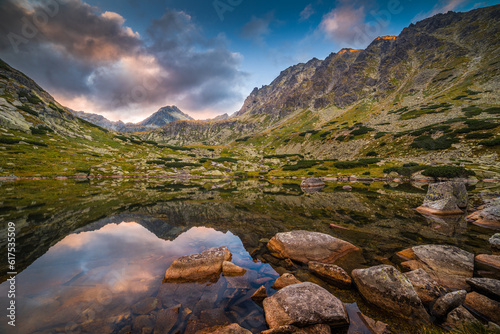 Mountain Lake Above Skok Waterfall with Rocks in Foreground and Strbsky Peak in Background at Sunset. Mlynicka Valley, High Tatra, Slovakia.