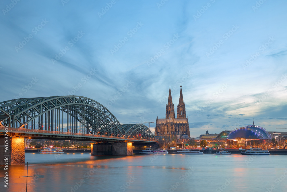 Fototapeta premium Panoramic view of the Rhine river at sunset as it passes through the city of Cologne in Germany.