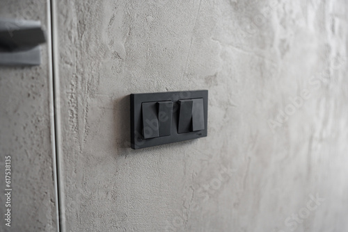 black light switch keys on a gray wall.  © andrey