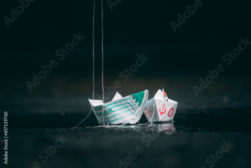 paper boats are standing on the street in a puddle