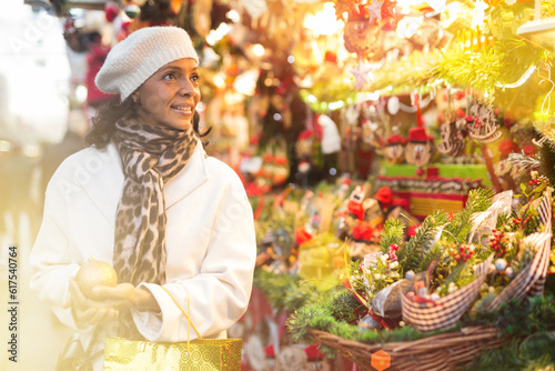 Woman are preparing for Christmas and choosing balls on the tree