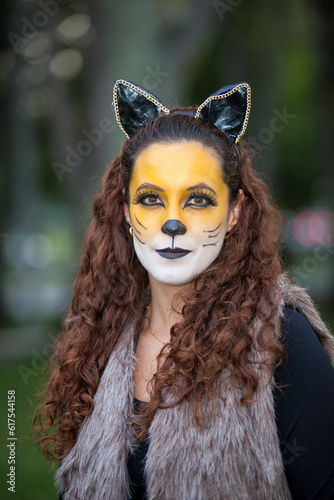 Beautiful young woman wearing a wolf costume. Real family having fun while using costumes of the Little red riding hood tale in Halloween.