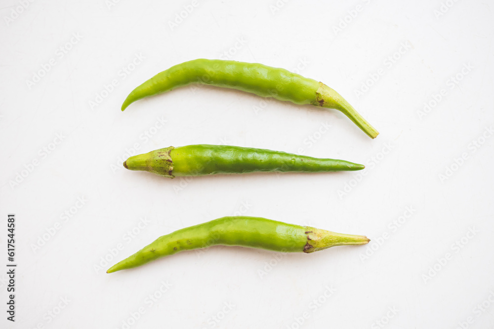Green hot chili peppers on white background