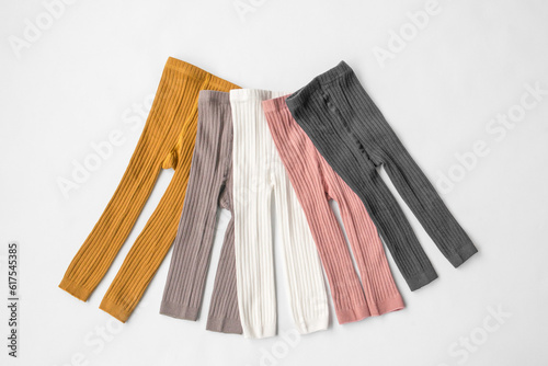 Children's multi-colored leggings. White background. Top view. Children's wardrobe. High quality photo