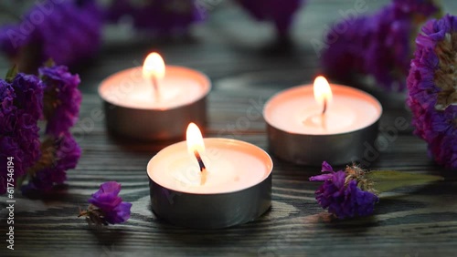 Candle. Tea Lights Candle. Mini Tealight candles for home decoration. Flowers on wooden table. Dripless and long lasting paraffin or white beeswax. Good for essential oil diffuser or aroma lamps. photo