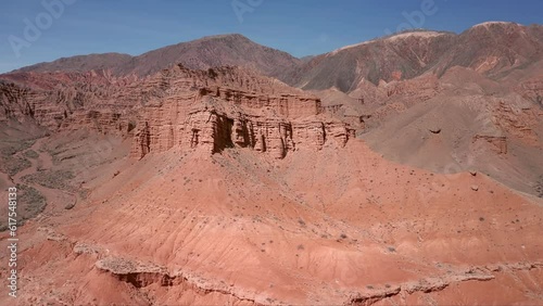Сamera flyover around the dining room mountain in the Red Canyon amidst the mountains. The deserted Red Canyon on a bright sunny day