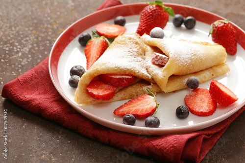 Thin pancakes crepes with berries for dessert