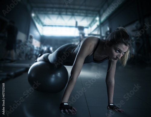 Muscular woman trains with fitness ball and wears sports underwear at the gym © Designpics