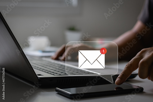 New email notification concept for business e-mail communication and digital marketing. Inbox receiving electronic message alert. Hand of businessman using smartphone for email with notification alert