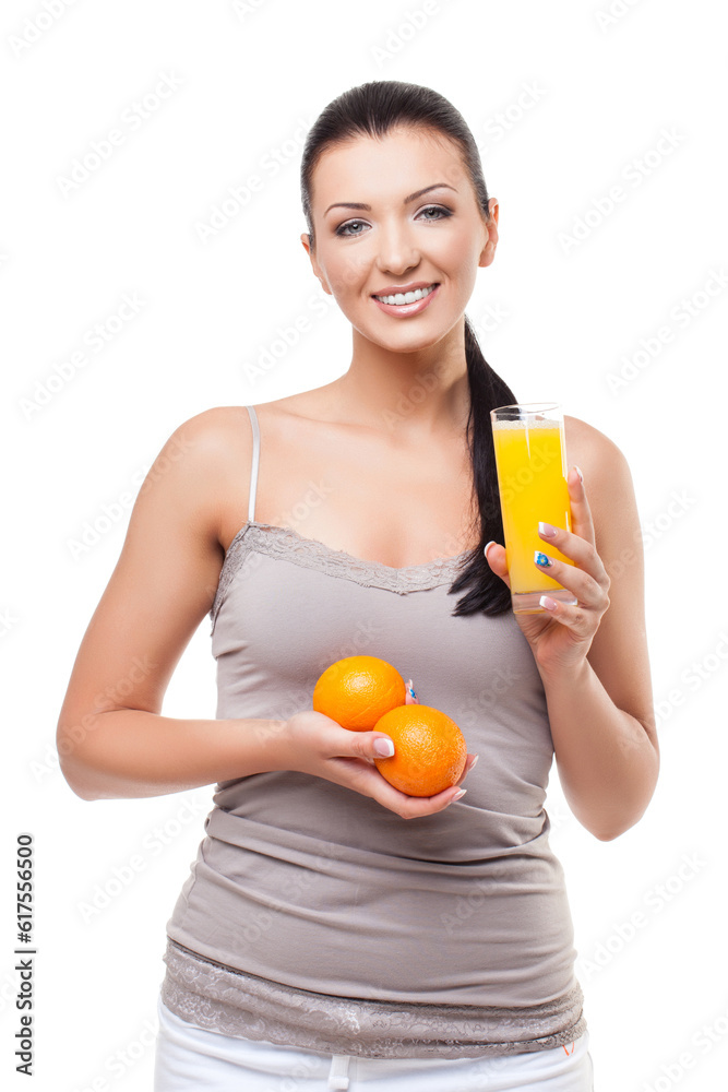 Beautiful happy young woman holding glass of orange juice and fresh oranges. Isolated on white background. Copy space. Beautiful happy young woman holding glass of orange juice and fresh oranges. Isolated on white background. Copy space.