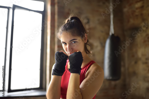 Young woman during a boxing training. Female boxer doing fitness. Regular sports boosts immune system and promote good health and resistance to diseases.