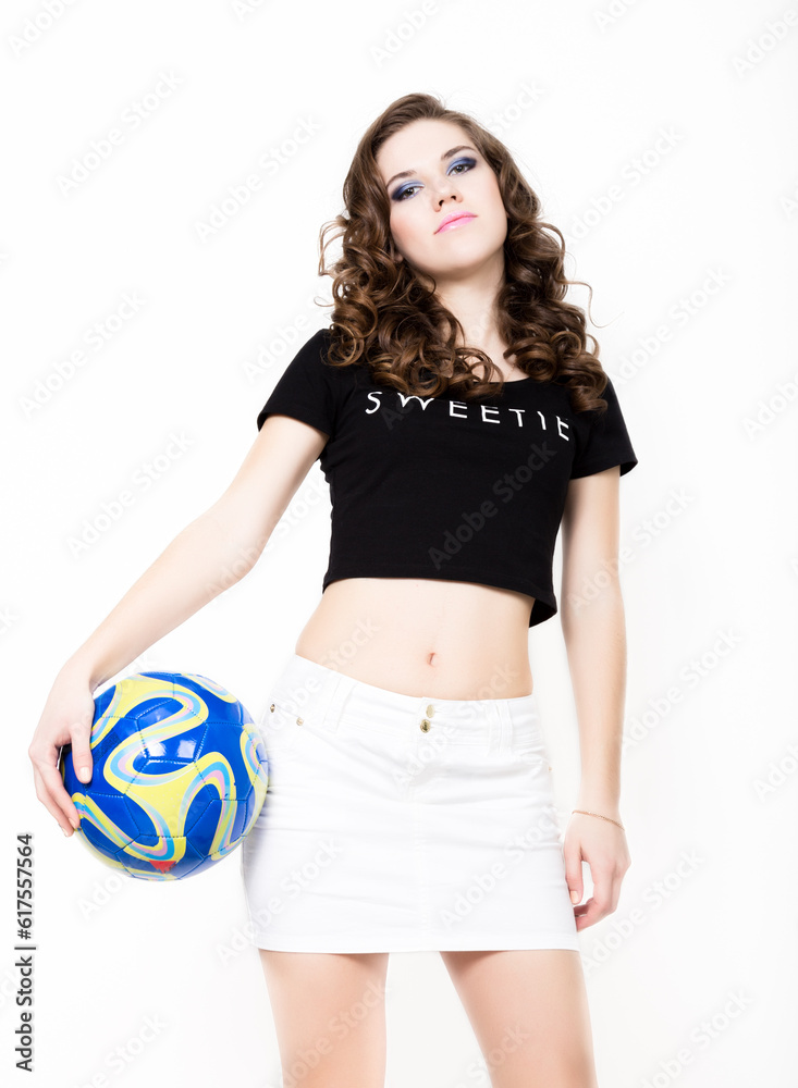 Young beautiful curly girl with professional make-up, holding a ball. Young beautiful curly girl with professional make-up, holding a ball.