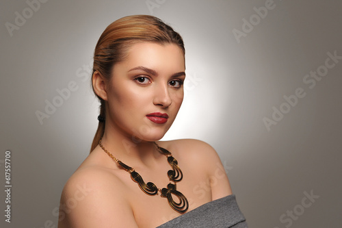 Studio portrait of a beautiful young woman with make-up and sparkle on lips
