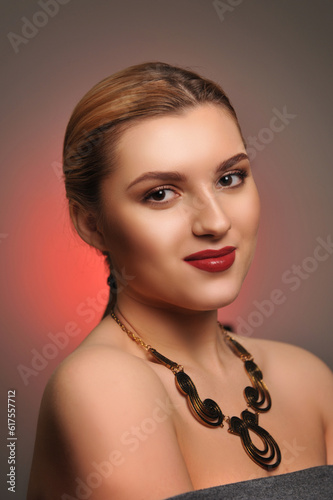 Studio portrait of a beautiful young woman with make-up and necklace