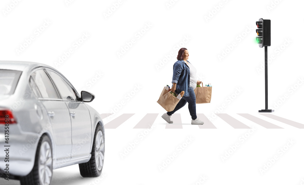 Corpulent woman with grocery bags crossing a street and car waiting at pedestrian crosswalk Corpulent woman with grocery bags crossing a street and car waiting at pedestrian crosswalk