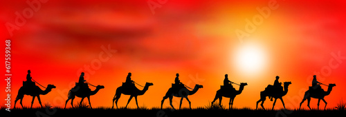 Silhouettes of riders on camels on the background of sunset.