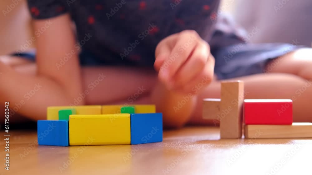 smart child, schoolboy playing with educational toy, wooden geometric figures, blocks in boy's hands, developing brain games, concept childhood, earlier child development, creativity, early training