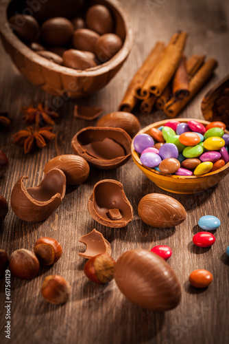 Assorted chocolate eggs for Easter on wooden background