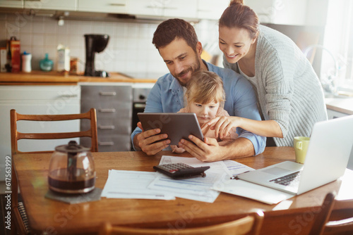 Young family using a digital tablet in the morning