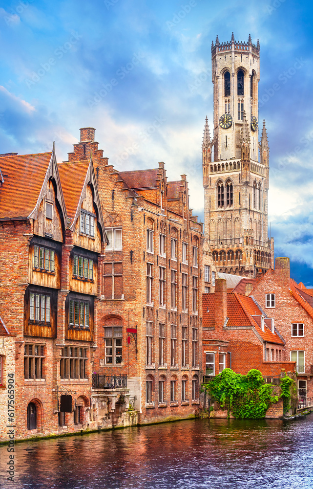 Medieval bell tower Belfort van Brugge in town Bruges Belgium vintage house on bank channel old Europe landscape.